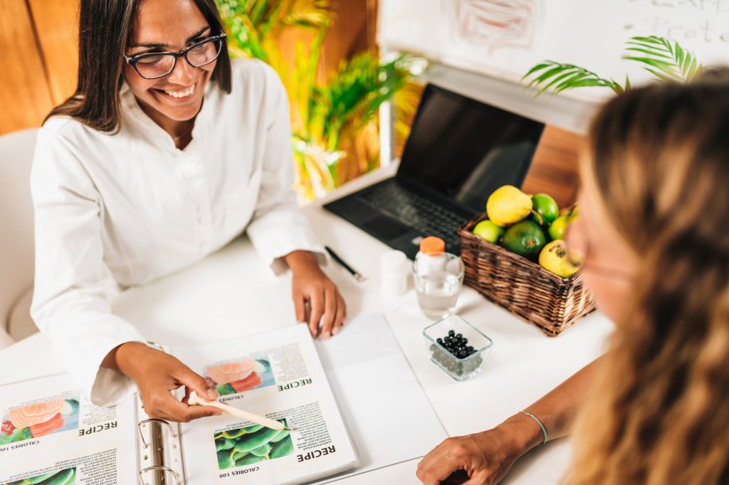 Nutritionist and Client Discussing Balanced Nutrition Plan