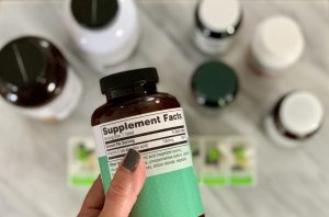 Reading the label on supplement pill bottle